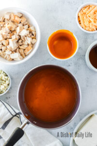 buffalo sauce and honey mixed in a sauce pan.