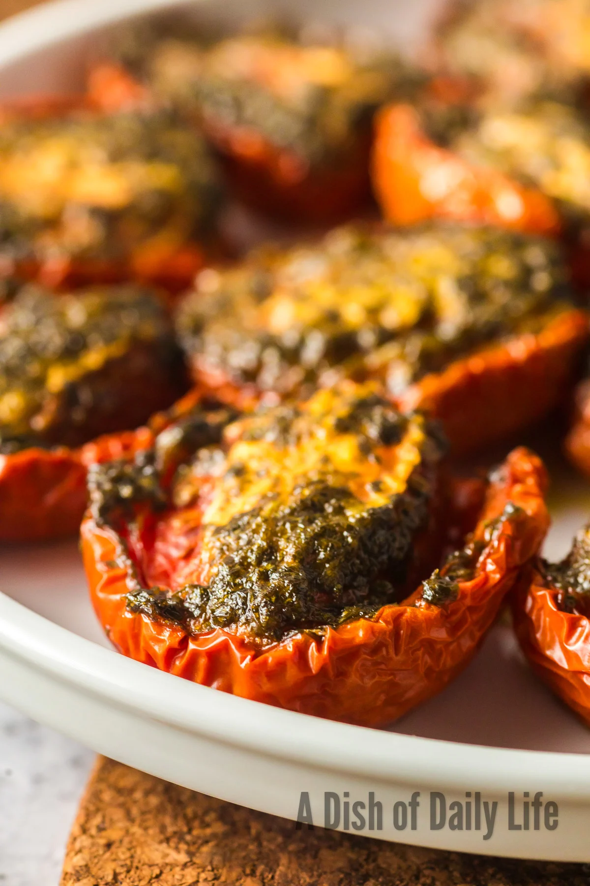 side view of baked cilantro tomatoes on plate