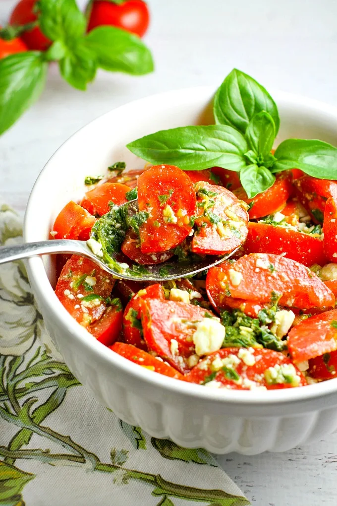 Colorful, healthy, and packed with flavor, this easy Tomato, Basil and Feta Summer Salad is the perfect side dish for any summer dinner, and even makes for a wonderful light lunch as well. Go ahead and customize it by adding in cucumber or even summer corn...the basil dressing goes well with everything!