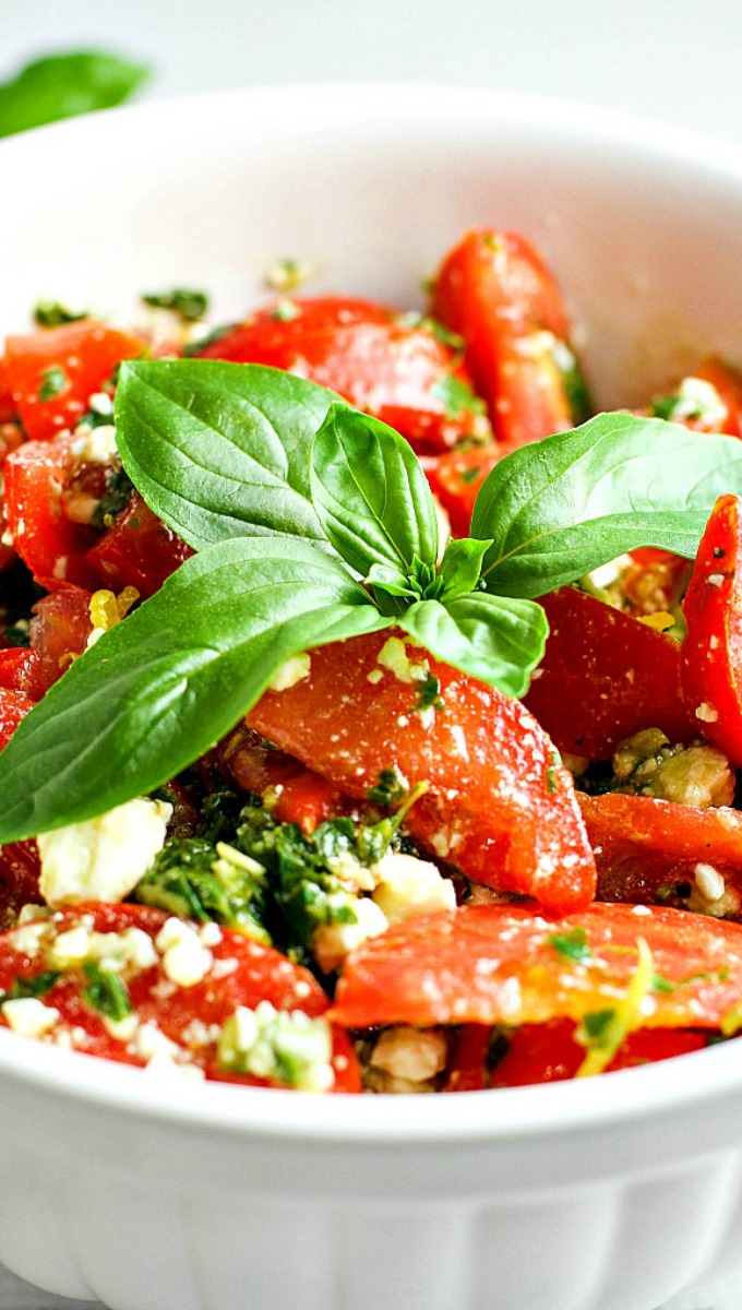 Colorful, healthy, and packed with flavor, this easy Tomato, Basil and Feta Summer Salad is the perfect side dish for any summer dinner, and even makes for a wonderful light lunch as well. Go ahead and customize it by adding in cucumber or even summer corn...the basil dressing goes well with everything!