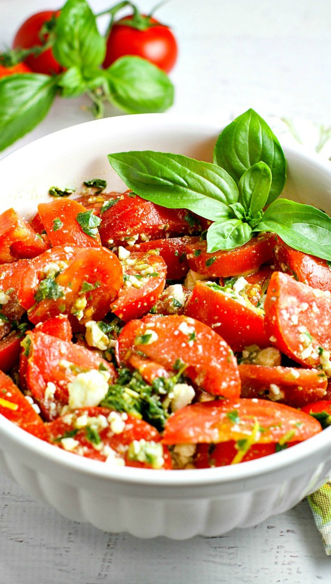 Colorful, healthy, and packed with flavor, this easy Tomato, Basil and Feta Summer Salad is the perfect side dish for any summer dinner, and even makes for a wonderful light lunch as well. Go ahead and customize it by adding in cucumber or even summer corn...the basil dressing goes well with everything!