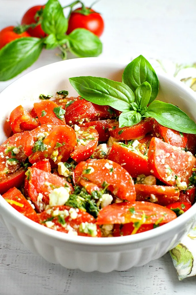 Colorful, healthy, and packed with flavor, this easy Tomato, Basil and Feta Summer Salad is the perfect side dish for any summer dinner, and even makes for a wonderful light lunch as well. Go ahead and customize it by adding in cucumber or even summer corn…the basil dressing goes well with everything!