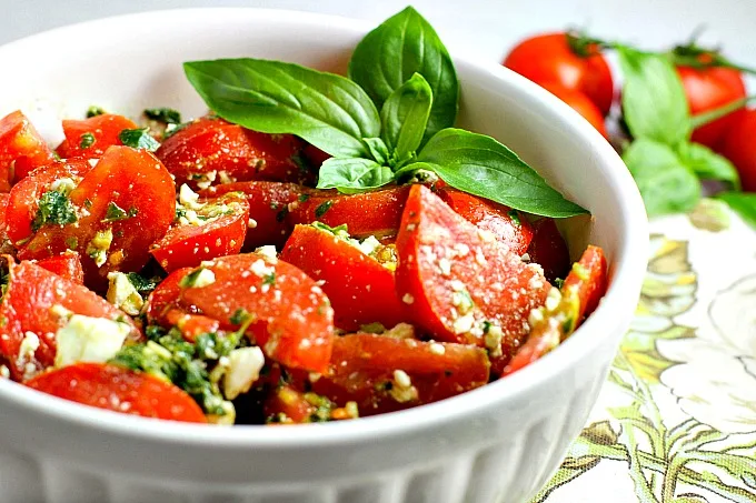 Colorful, healthy, and packed with flavor, this easy Tomato, Basil and Feta Summer Salad is the perfect side dish for any summer dinner, and even makes for a wonderful light lunch as well. Go ahead and customize it by adding in cucumber or even summer corn...the basil dressing goes well with everything!