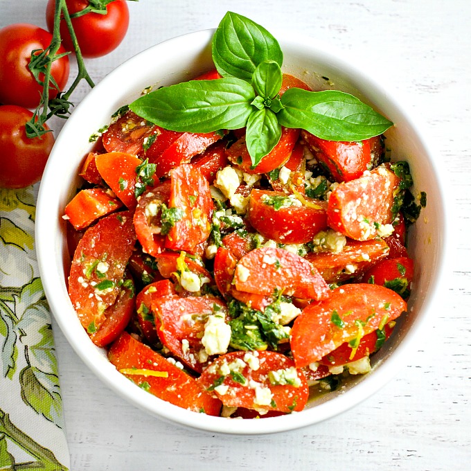 Tomato, Basil and Feta Salad...Colorful, healthy, and packed with flavor, this easy salad is a wonderful side dish for any summer dinner, and even makes for a wonderful light lunch as well. Go ahead and customize it by adding in cucumber or even summer corn…the basil dressing goes well with everything!