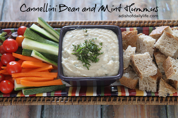 Cannellini Bean and Mint Hummus...an easy vegan appetizer recipe that takes minutes to make and will probably disappear in minutes too! If you're looking for something a bit healthier for tailgate season, this is it!