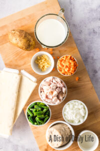 All ingredients for pot pie hand pies laid out on a cutting board.