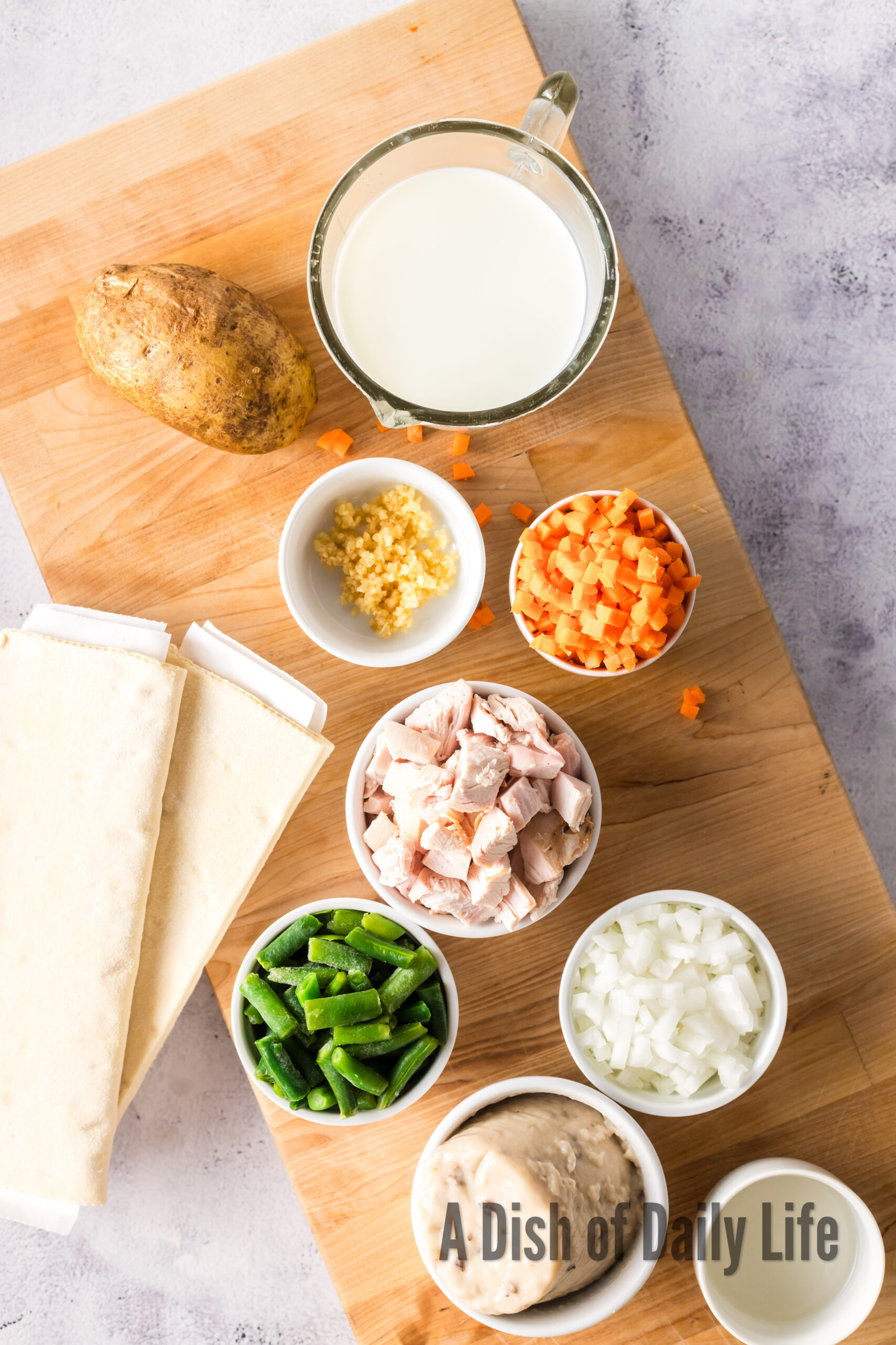 All ingredients for pot pie hand pies laid out on a cutting board.