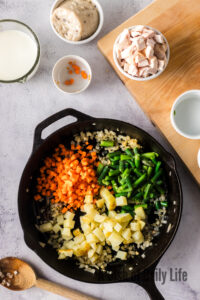 carrots, green beans and potato pieces added to skillet