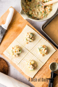 puff pastry cut into 4 pieces with a dollop of filling in the middle of each.