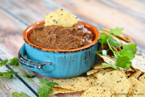 This Southwestern Bean Dip appetizer is packed with veggies, and is great as a base for a layer dip, for burritos and quesadillas, and you can use it as refried beans too!