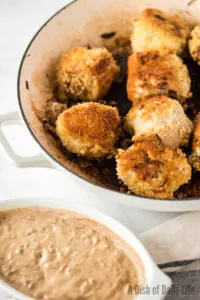 stuffed chicken with creamy sauce next to it