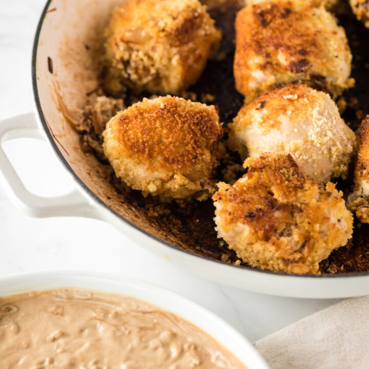 stuffed chicken with creamy sauce next to it