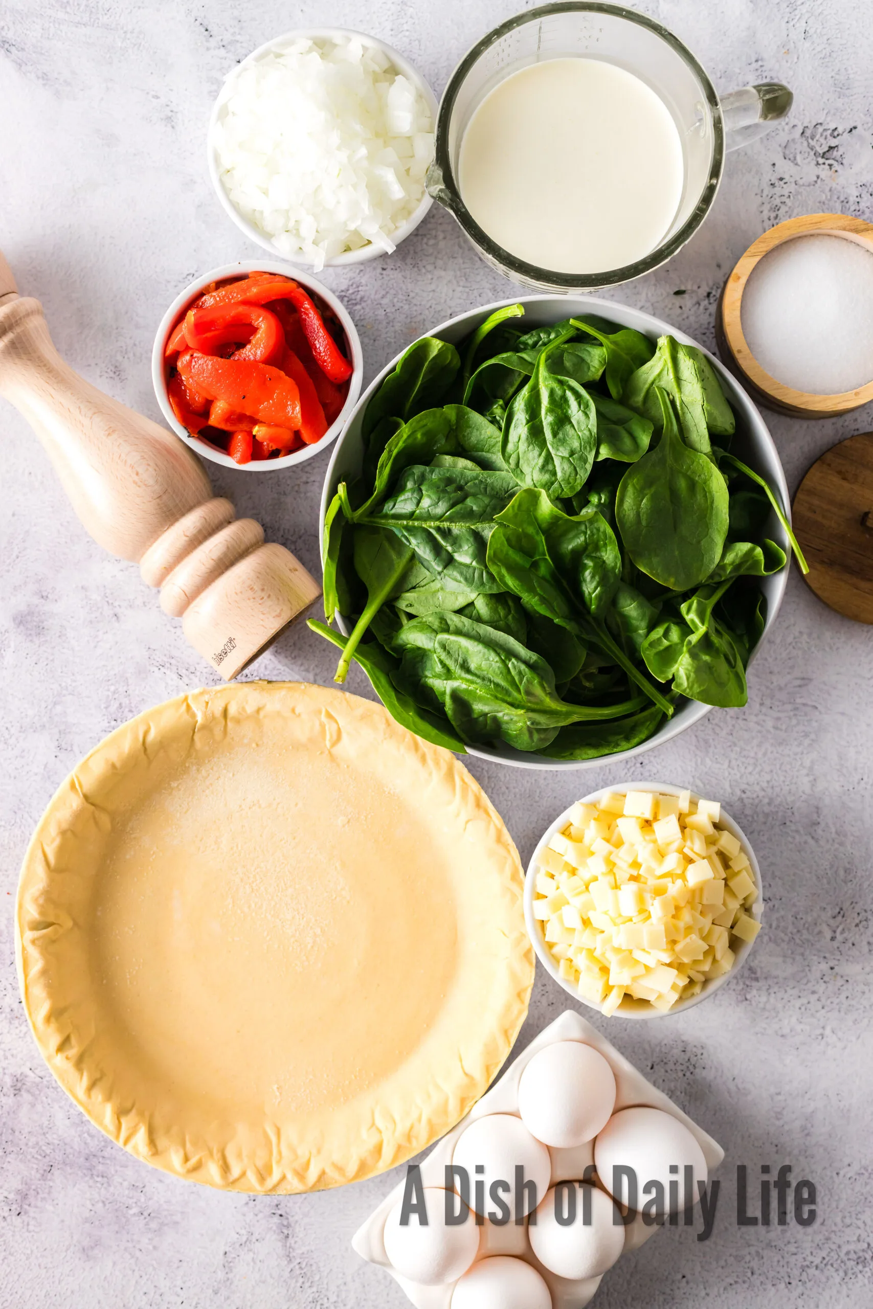 All ingredients laid out on counter for spinach quiche