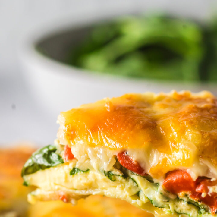 a slice of quiche being removed from pan.