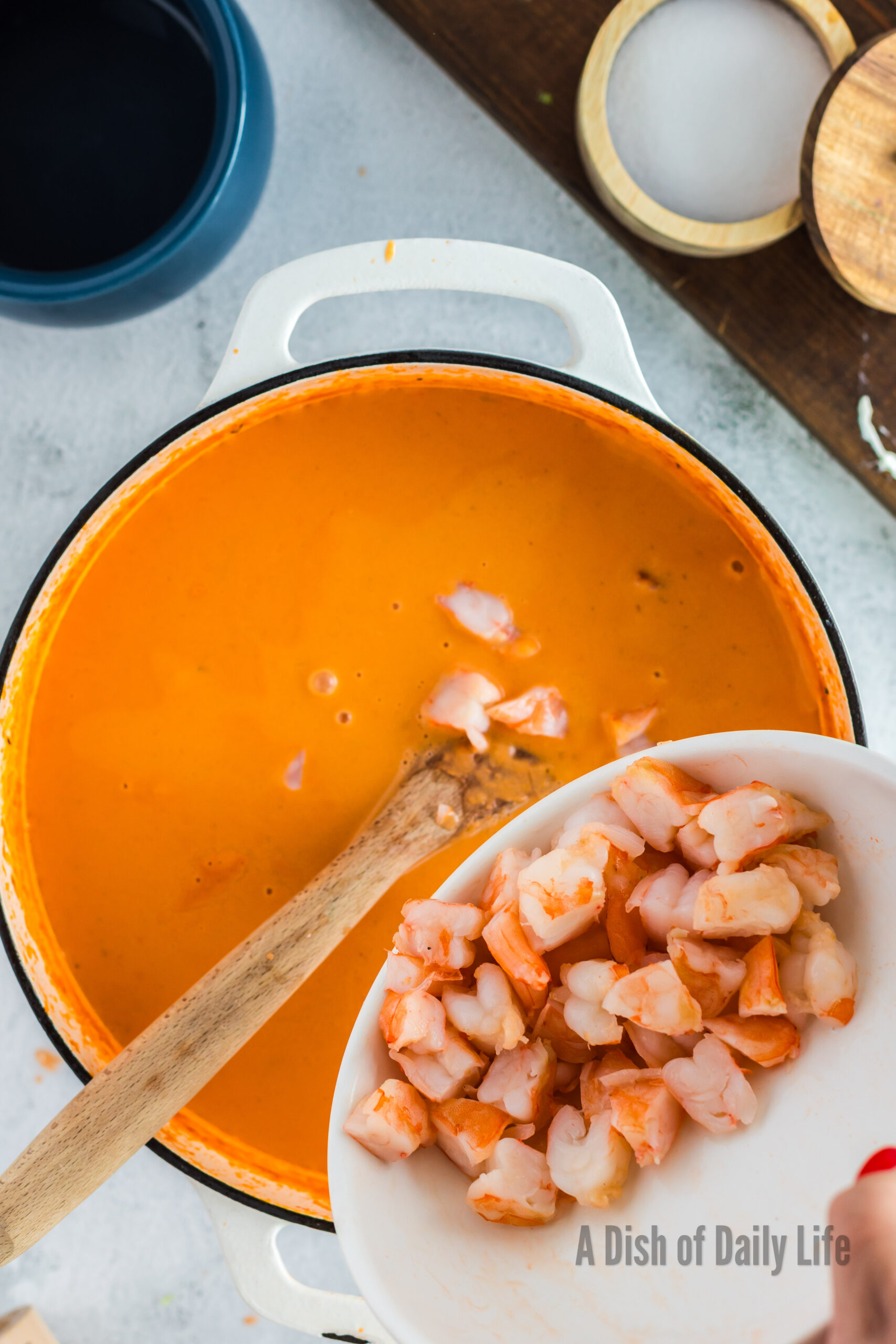 Cut up seafood added to bisque