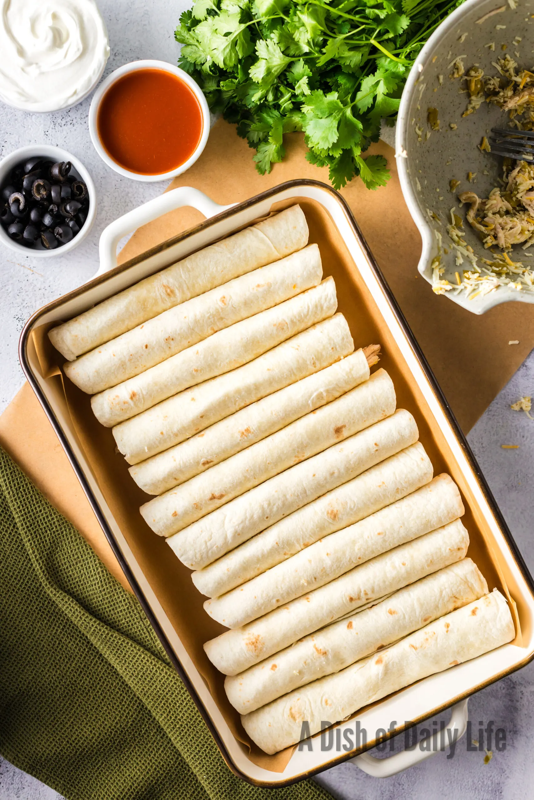 Pan full of rolled and filled enchiladas
