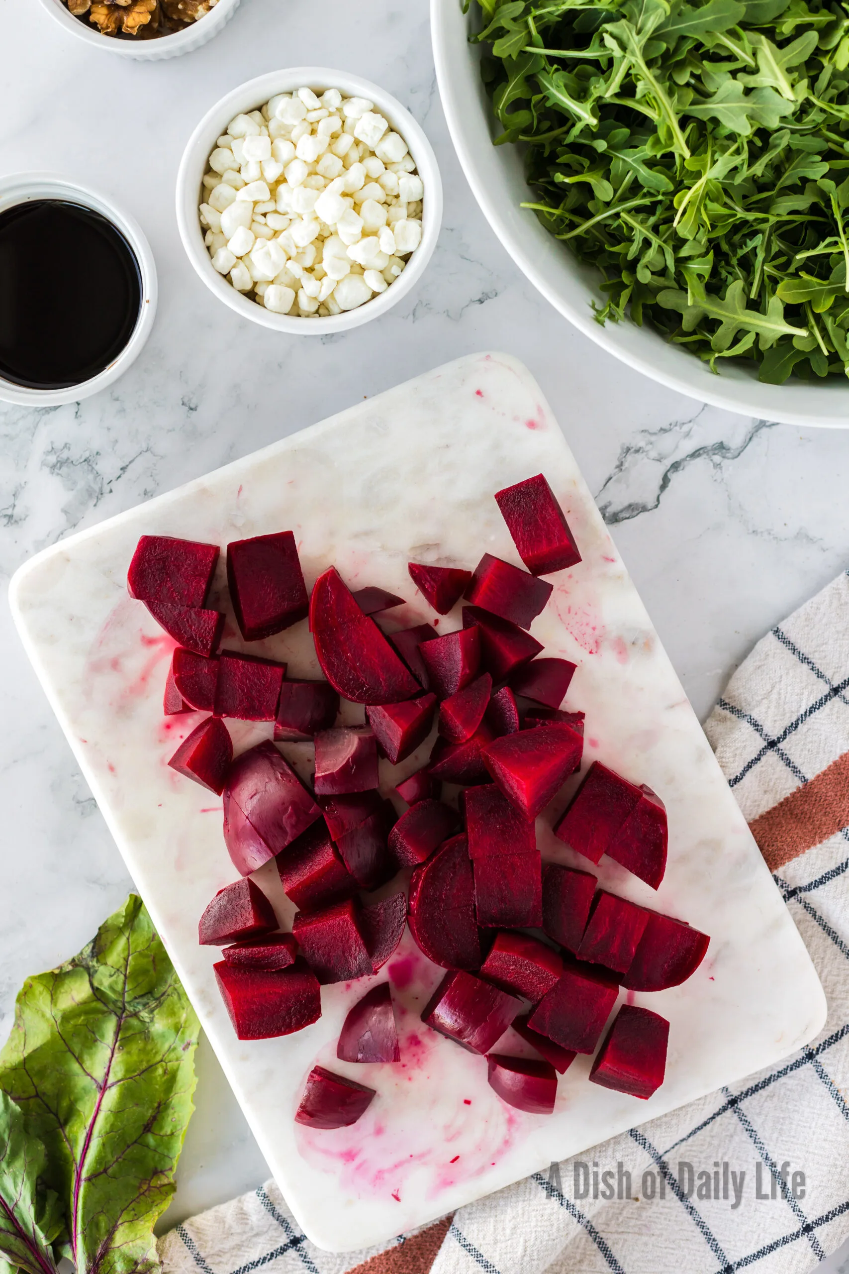 Cooked beets chopped up on a cutting board