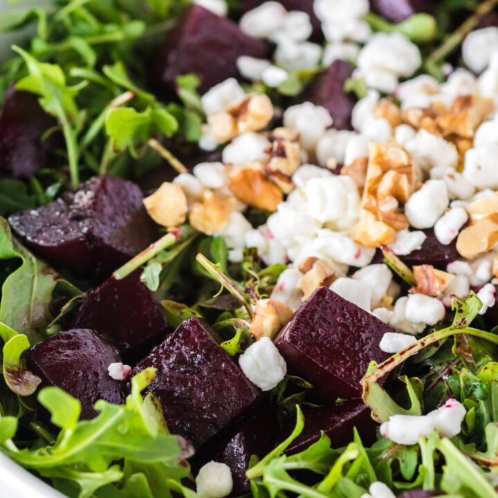 zoomed in image of beet salad in bowl with goat cheese