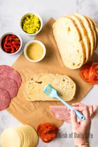 bread being brushed with Italian dressing