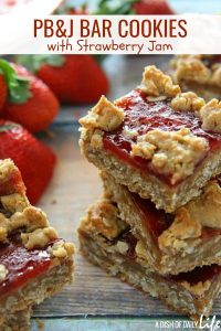 The classic sandwich becomes a cookie! PB&J Cookie Bars with Strawberry Jam are easy to make, and a delicious way to satisfy your sweet tooth craving. #cookies #barcookies #peanutbutterandjelly