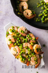 Cooked shrimp over a bed of rice in a serving dish.