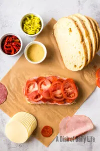 sliced tomatoes layered on top of salami
