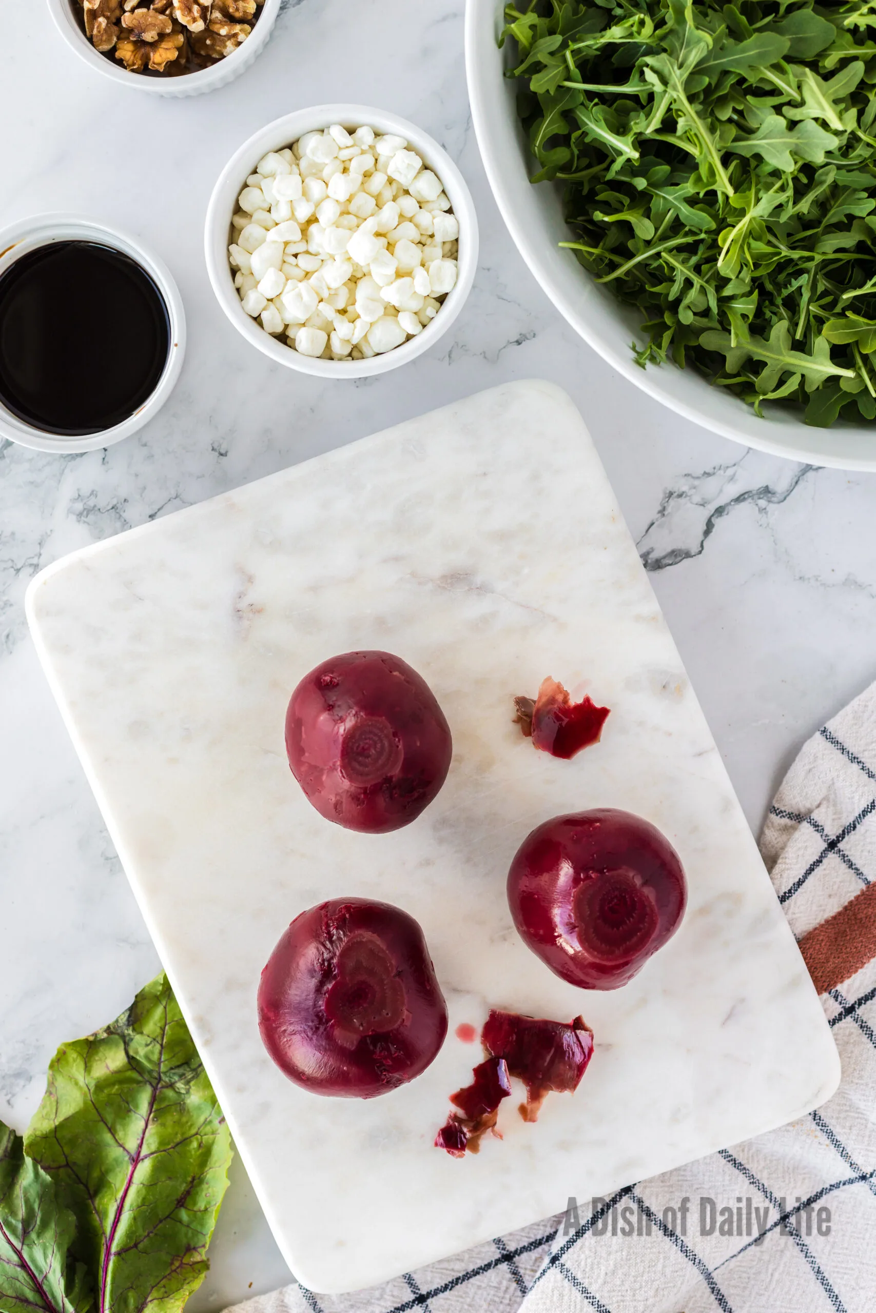 Cooked and peeled beets on cutting board