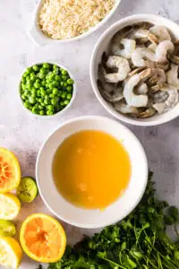 Lemon zest, lemon juice, orange juice and lime juice mixed in a bowl.