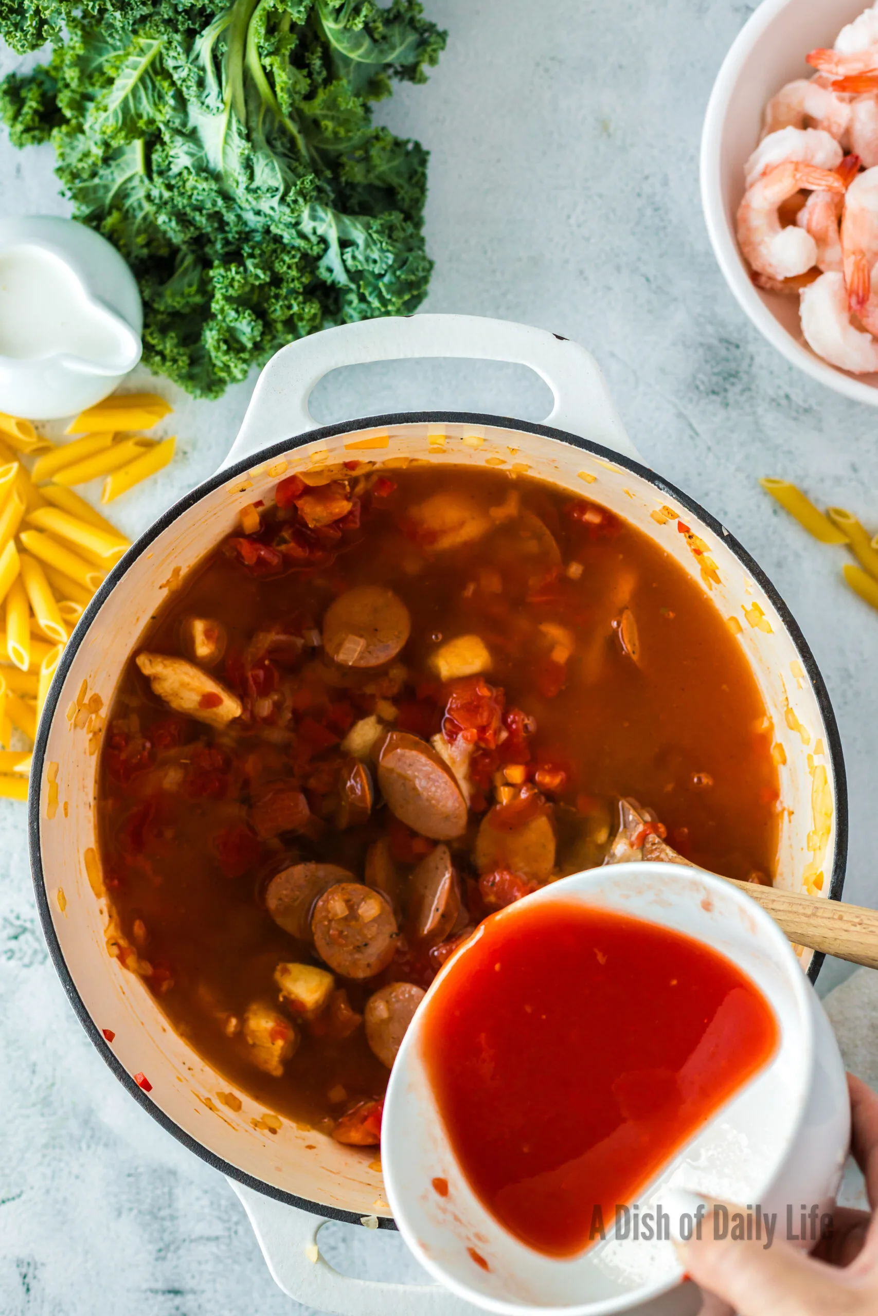 water and tomato liquid added to chicken and sausage