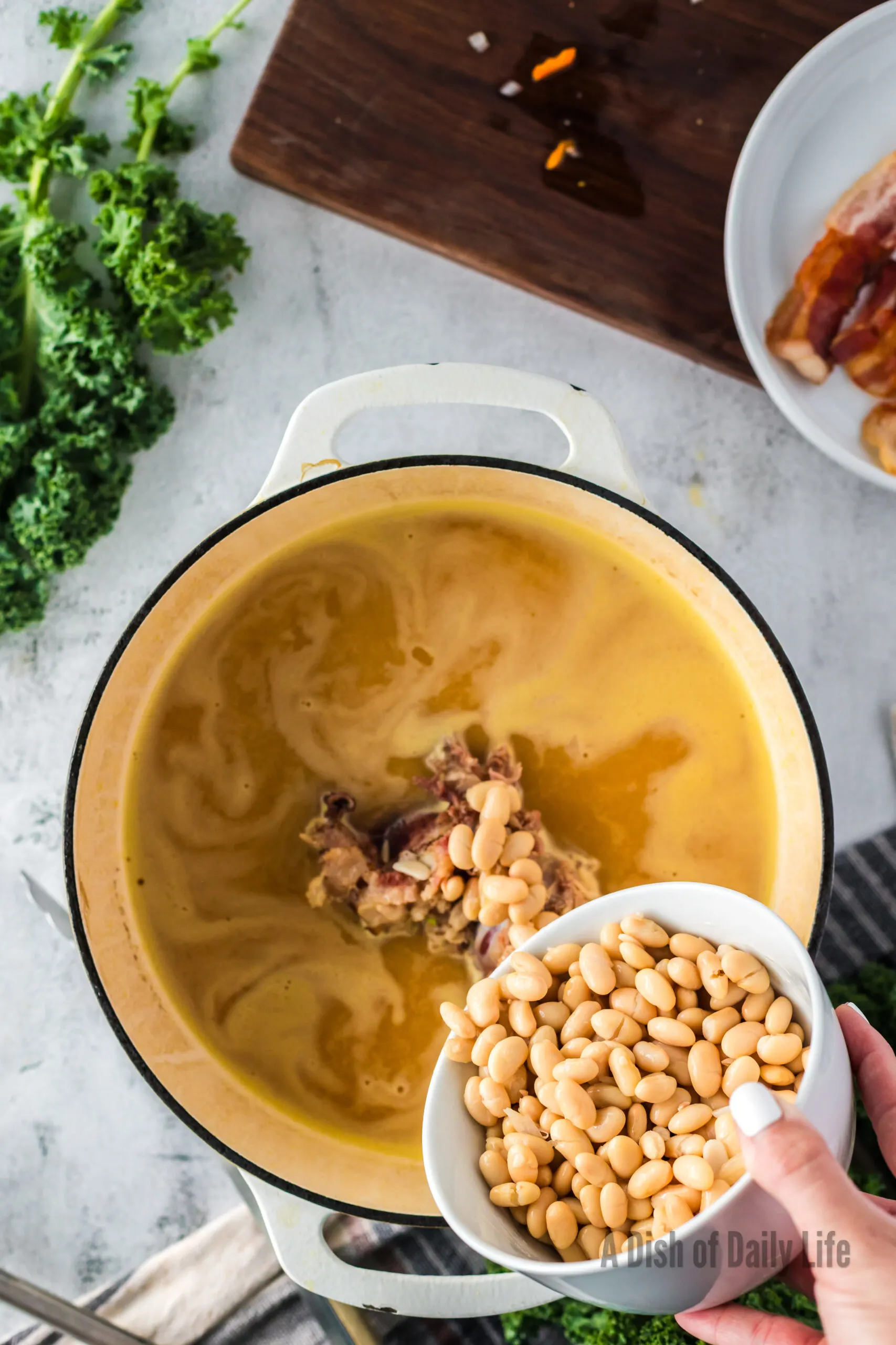 white beans added to soup pot