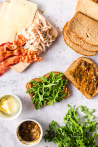 arugula on top of roasted garlic jam on bread