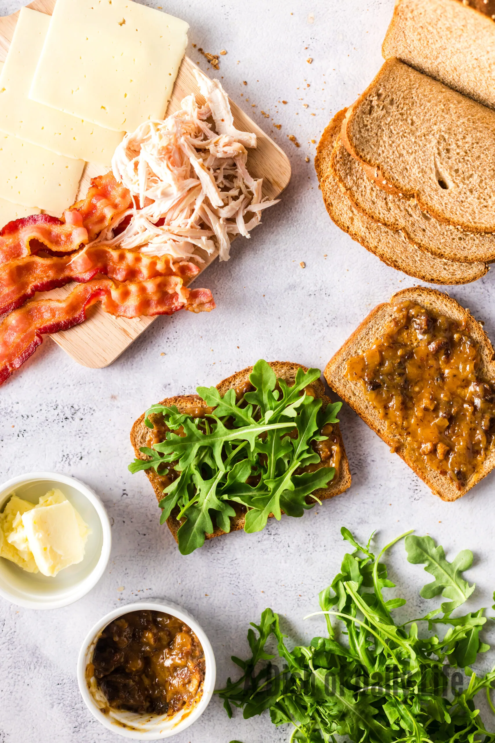 arugula on top of roasted garlic jam on bread