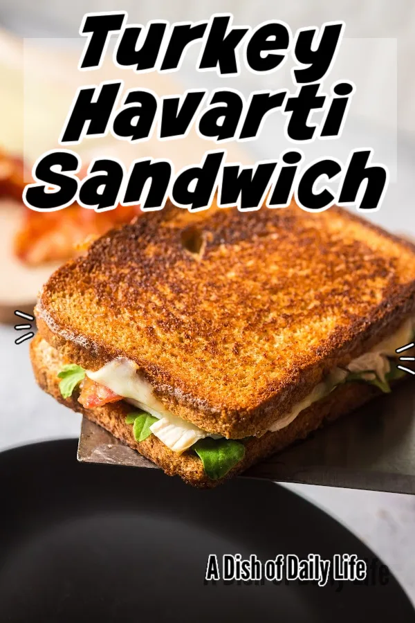 Main image for Turkey Havarti Sandwich recipe. Spatula scooping sandwich out of pan.