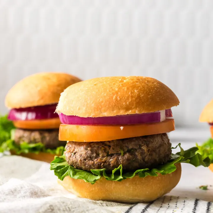 zoomed out image of burgers on counter fully loaded