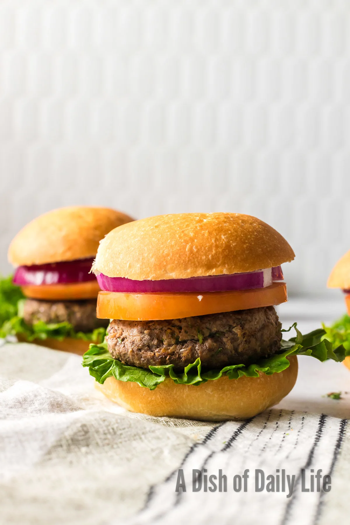 zoomed out image of burgers on counter fully loaded