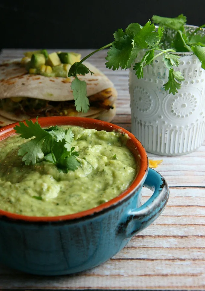 Pulled Pork Quesadillas...pulled pork, sweet corn, and melted cheese layered between flour tortillas, and topped with a tangy tomatillo guacamole...a delicious alternative for Mexican night!