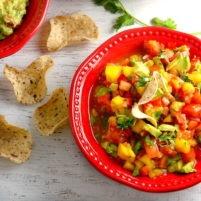 Get ready for a flavor explosion of deliciousness with this Avocado Mango Salsa recipe! This crowd pleaser is great as a party appetizer served with chips, or served as an accompaniment to seafood or chicken.