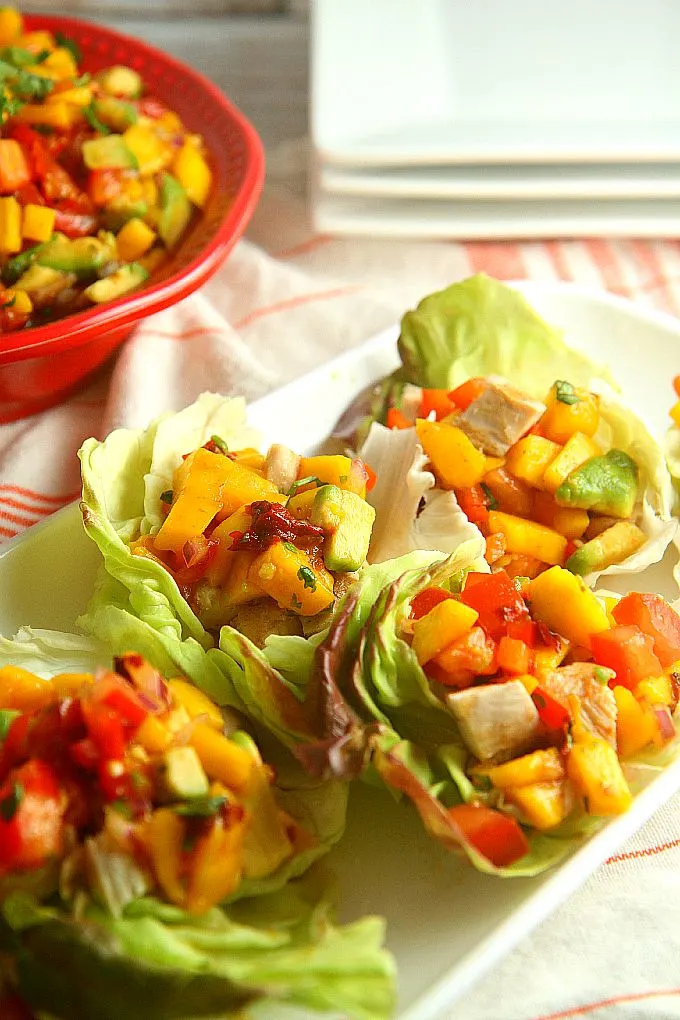 Healthy and delicious, these Chicken Lettuce Wraps with Avocado Mango Salsa are an easy dinner that you can have on the table in less than 30 minutes! 