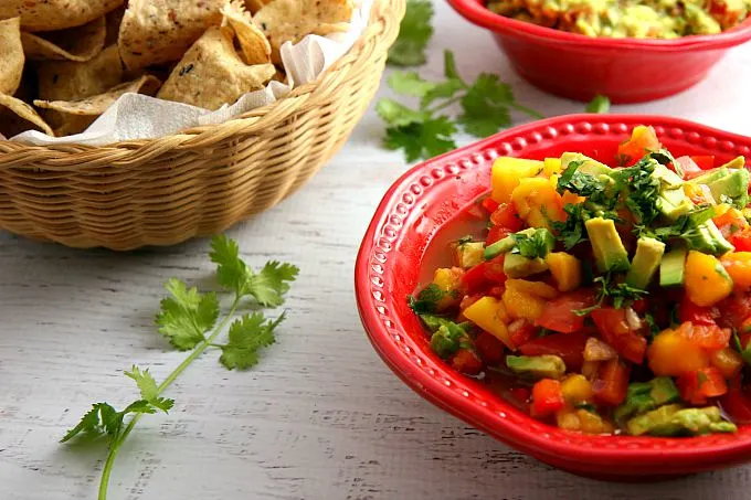 Get ready for a flavor explosion of deliciousness with this Avocado Mango Salsa recipe! This crowd pleaser is great as a party appetizer served with chips, or served as an accompaniment to seafood or chicken.