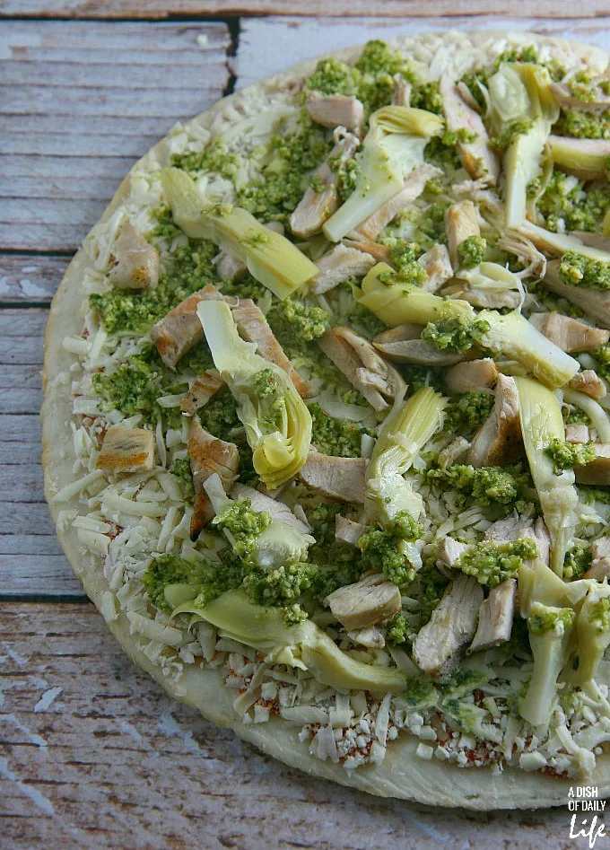 Pesto, artichoke heart and chicken pizza, ready for grilling