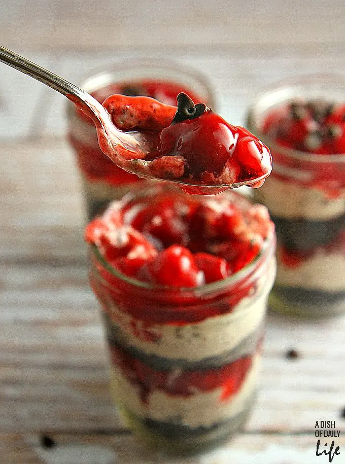 No need to heat the kitchen up! These No Bake Cherry Chocolate Cheesecake Parfaits are the perfect dessert recipe for barbeques or dinner parties, and they're easily transported in individual serving mason jars! 