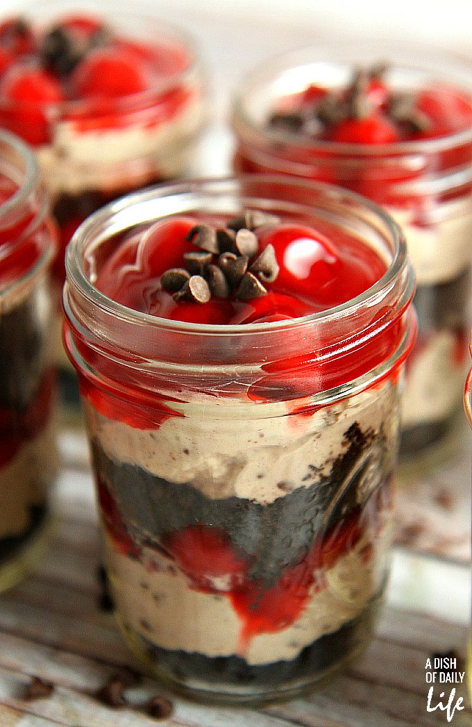 No need to heat the kitchen up! These No Bake Cherry Chocolate Cheesecake Parfaits are the perfect dessert recipe for barbeques or dinner parties, and they're easily transported in individual serving mason jars! 