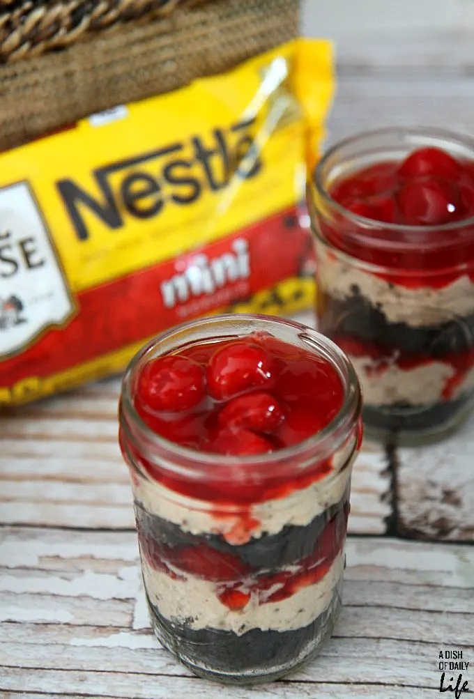 No need to heat the kitchen up! These No Bake Cherry Chocolate Cheesecake Parfaits are the perfect dessert recipe for barbeques or dinner parties, and they're easily transported in individual serving mason jars!