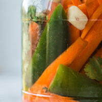side view of carrots and jalapenos in jar