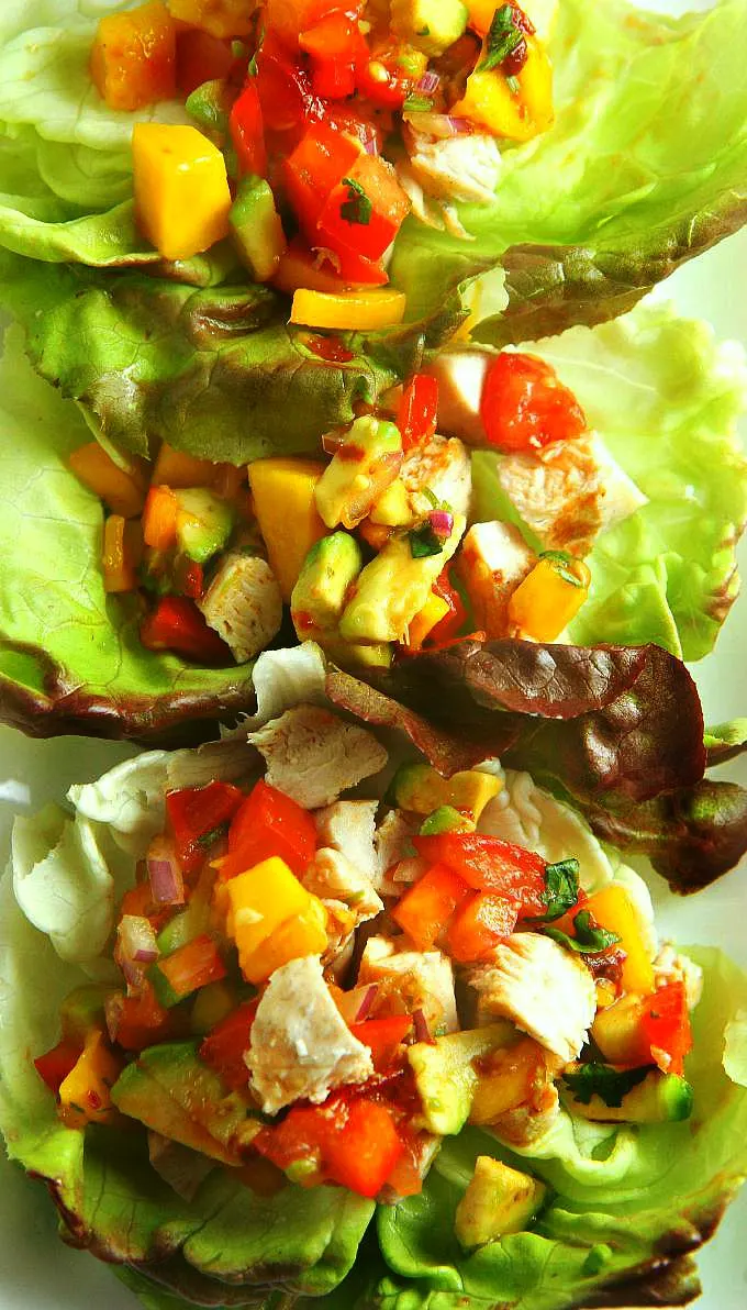 Healthy and delicious, these Chicken Lettuce Wraps with Avocado Mango Salsa are an easy dinner that you can have on the table in less than 30 minutes! 