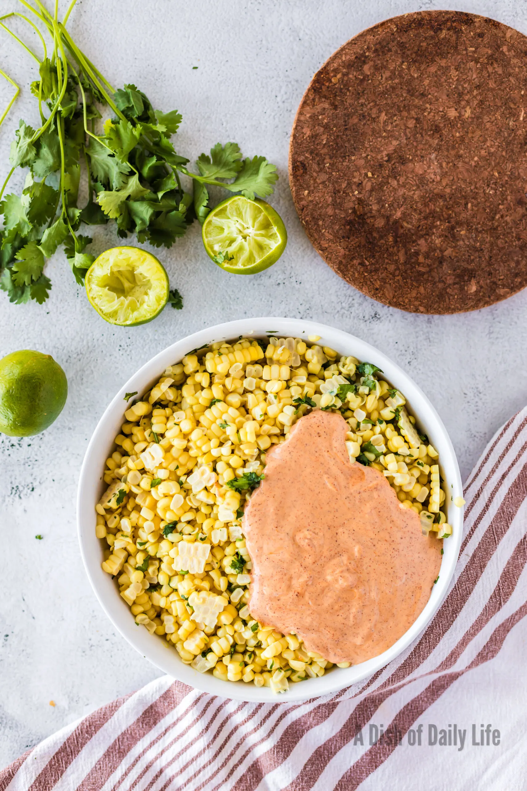 Dressing poured on top of corn and cilantro.