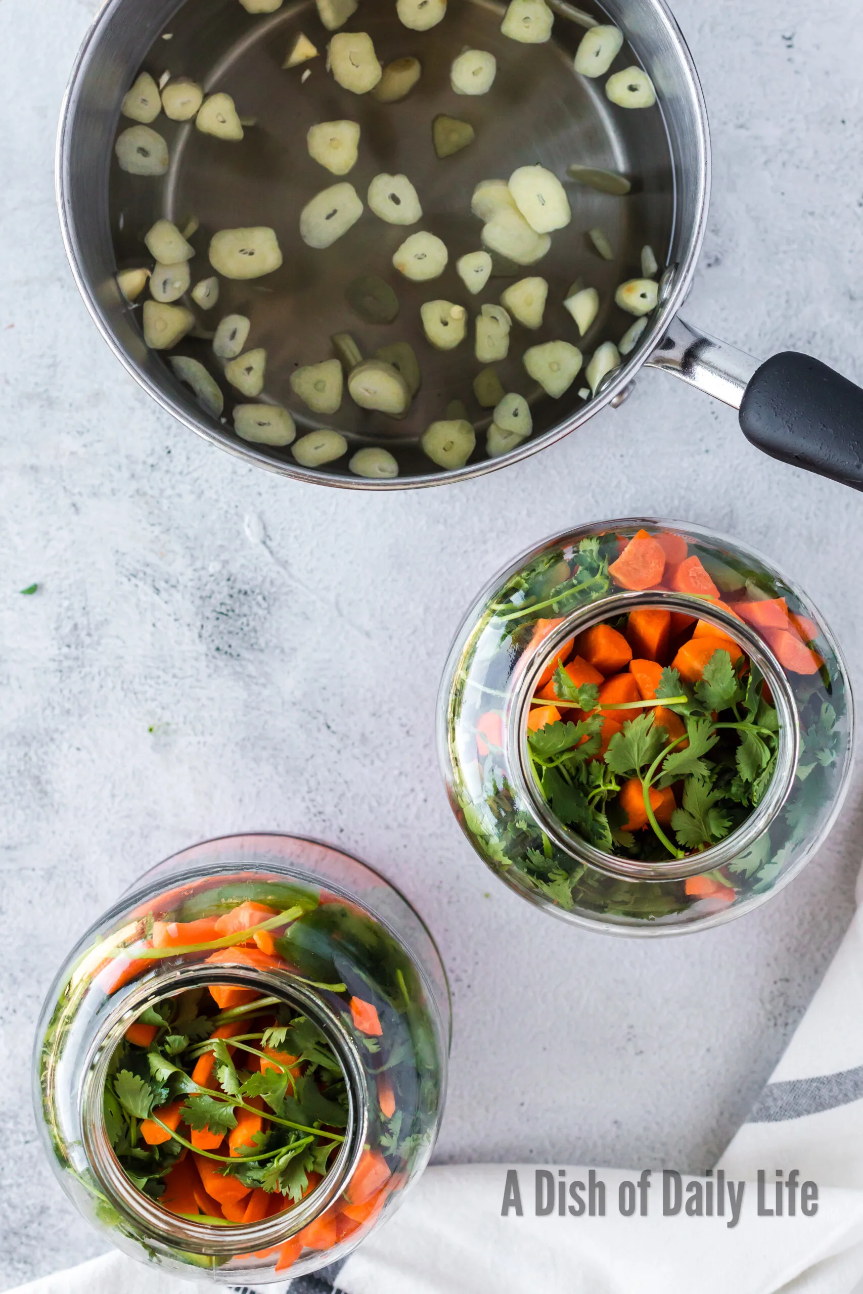 carrots, cilantro and jalapenos added to a jar