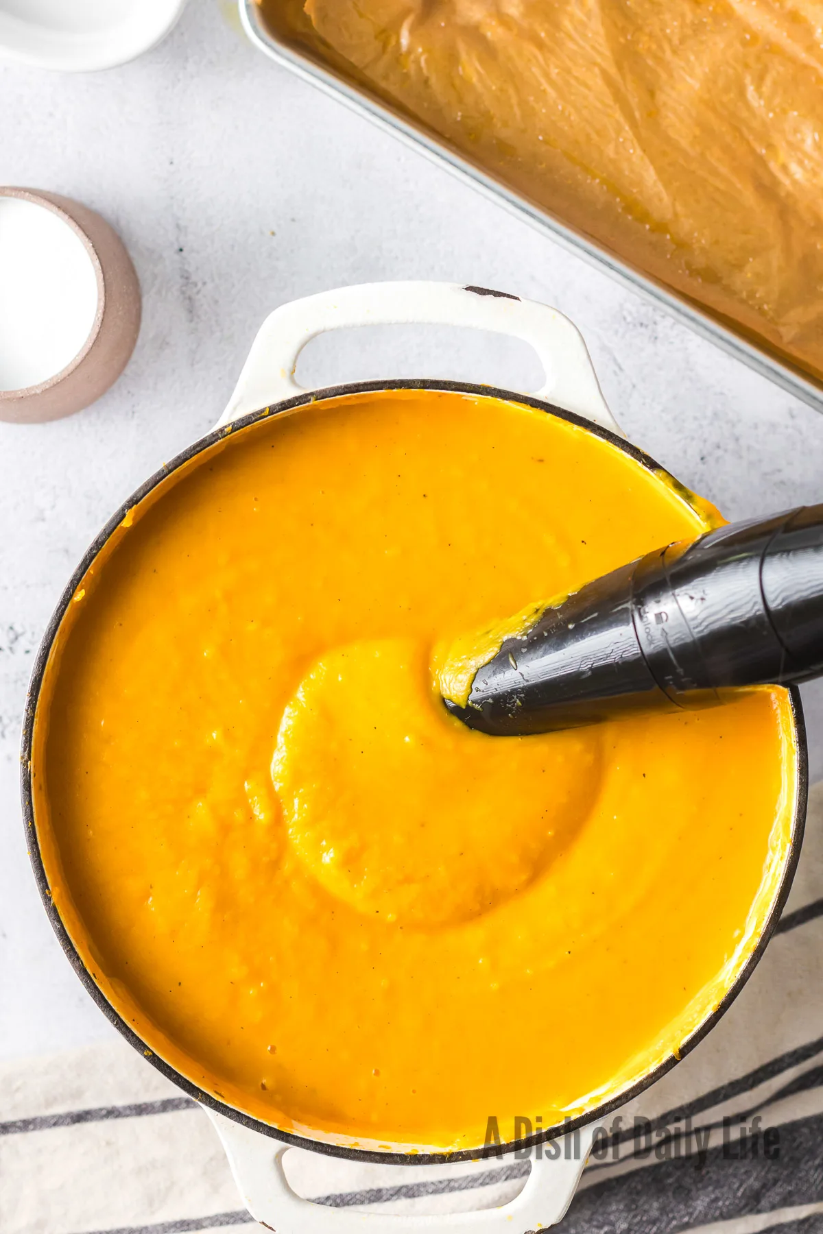 immersion blender in soup, making it nice and creamy