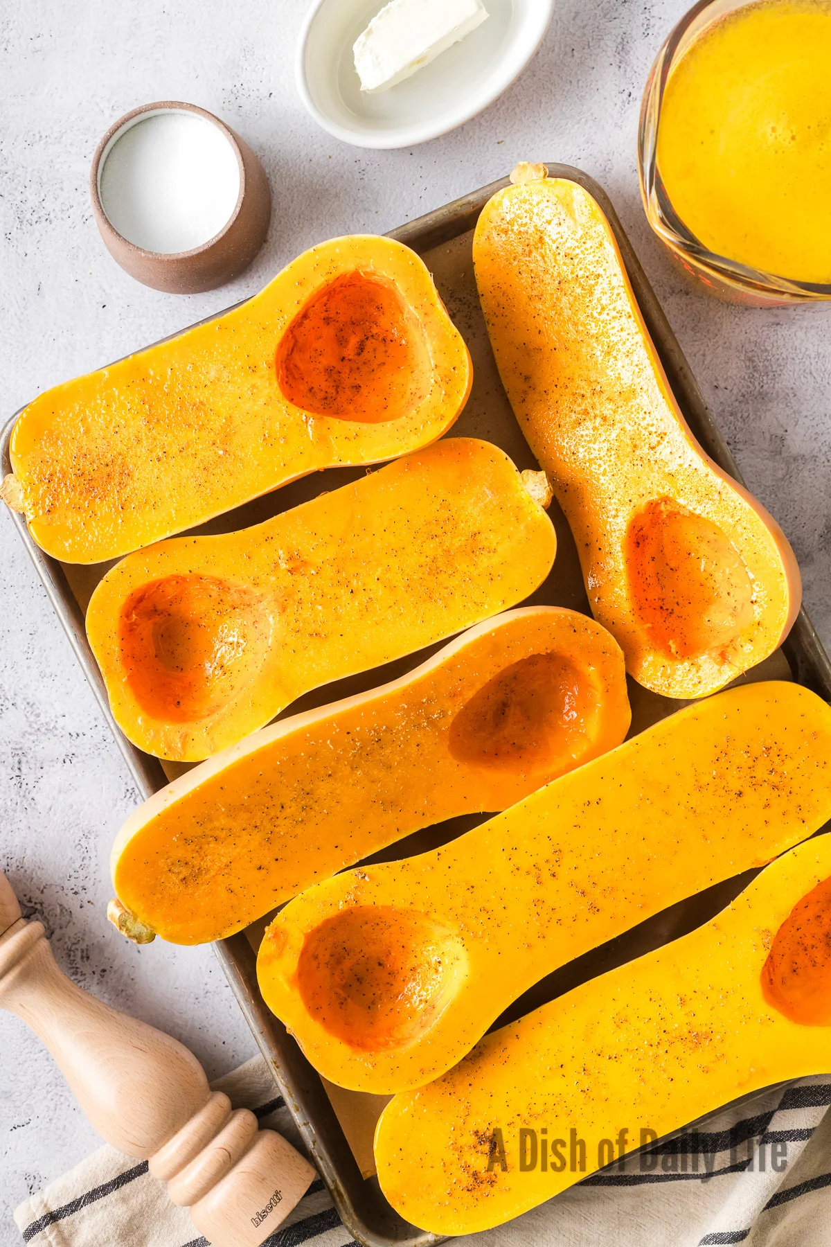3 butternut squashes cut in half and seeded, laying on a cooking sheet