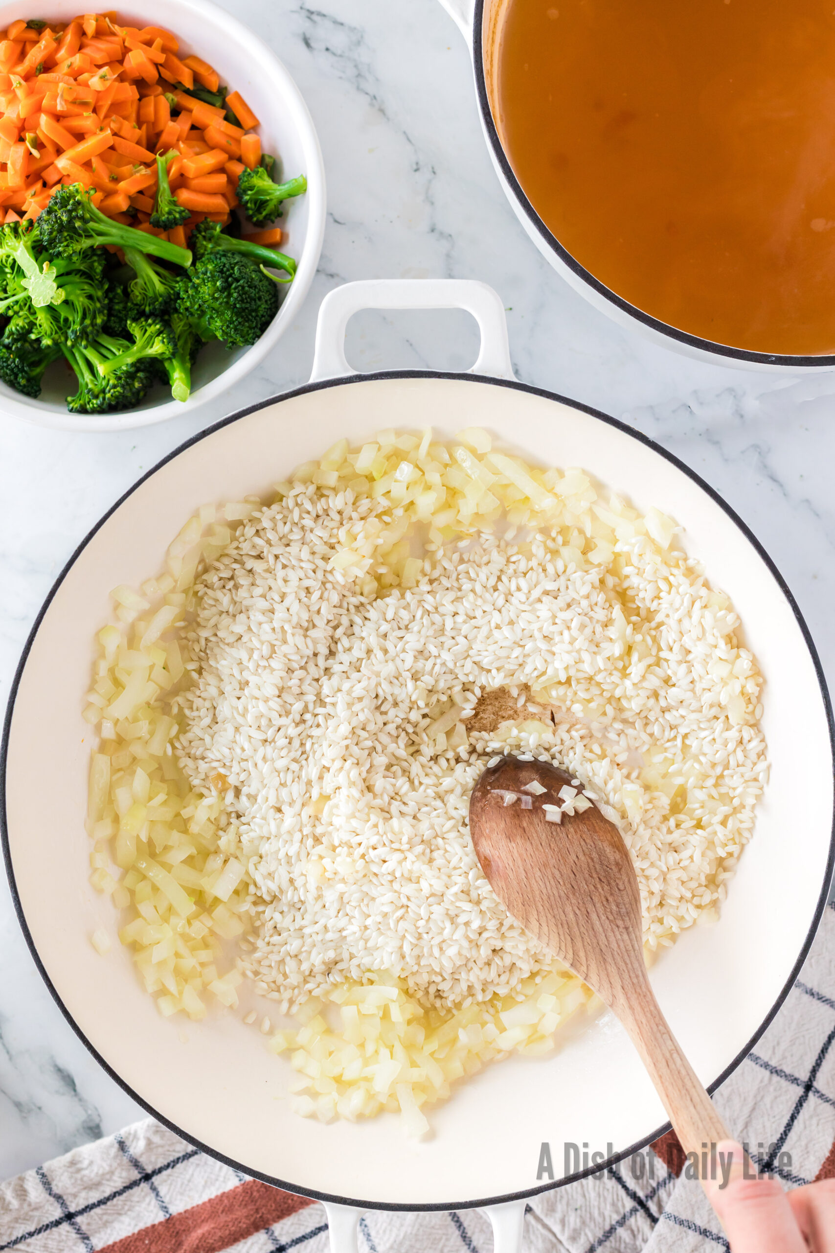 Sauteed onion in pan with rice added.